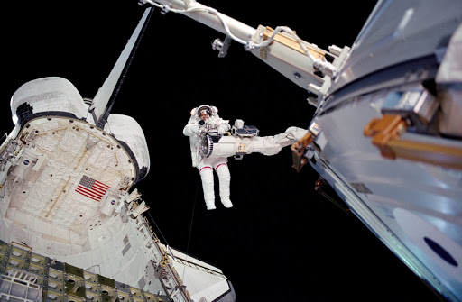 Barry on the RMS above the payload bay during EVA2