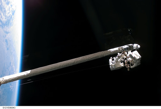 Fossum and Sellers on the OBSS during EVA1 on STS-121 / Expedition 13 joint operations