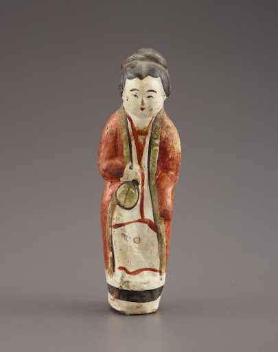 Female attendant holding a fan