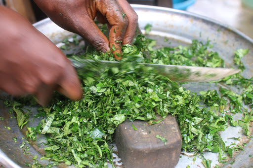 Chopping fluted pumpkin leaves