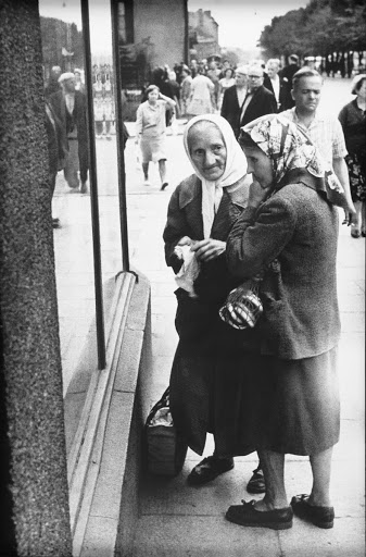 Two ladies in front of the window