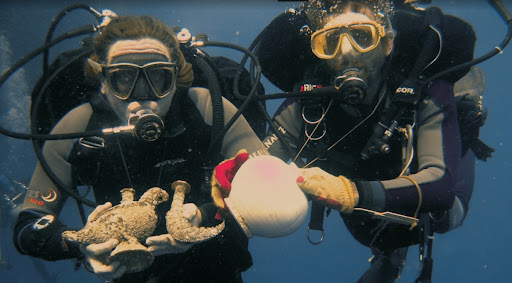 Diver uncovering artifacts at Cirebon shipwreck