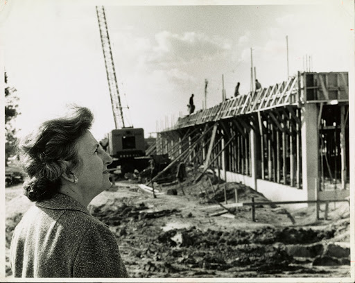 Bonnie Cone in front of a half-constructed J. Murrey Atkins Library