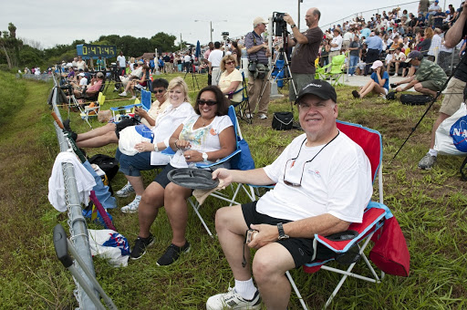 Spectators relax before the launch of space shuttle Atlantis on its STS-135 mission to the International Space Station.