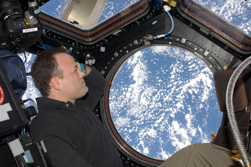 NASA astronaut Ron Garan Expedition views a point on Earth through one of the windows in the Cupola of the International Space Station.