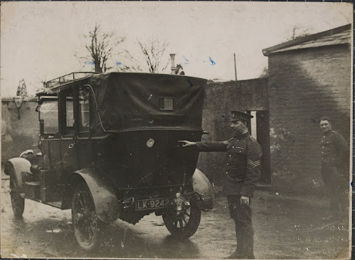The car in which Lord French was ambushed: sergeant pointing out bullet hole