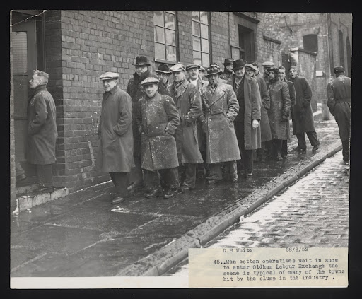 Daily Herald Photograph: Mill workers wait outside Oldham Labour Exchange