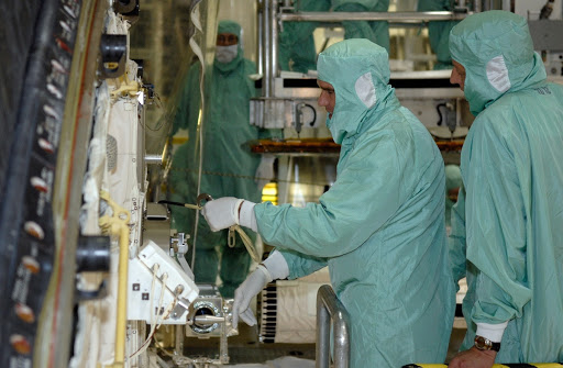 STS-126 Mission Specialist Steve Bowen left checks hardware in the space shuttle Endeavour's payload bay.