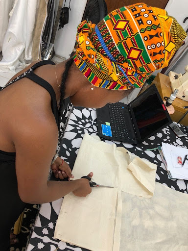 Keisha Edwards cutting fabric in her workshop