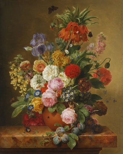 Flowers in a vase and plum branch on a marble tablet
