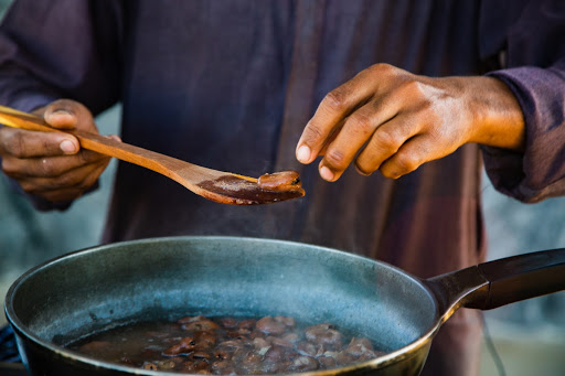 Checking a fava bean to see its consistency