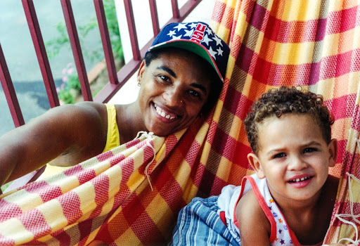 Mariléria dos Santos in her family's home with her nephew. Valença, Rio de Janeiro