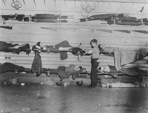 Caring for men wounded in invasion of France on board an American hospital ship, LST.