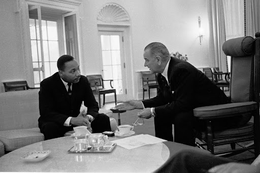 Martin Luther King, Jr. talks with President Lyndon B. Johnson.