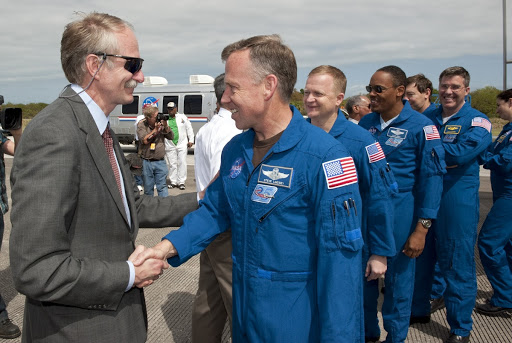 Bill Gerstenmaier greets the crew members as they exit after landing at NASA's Kennedy Space Center aboard Discovery.