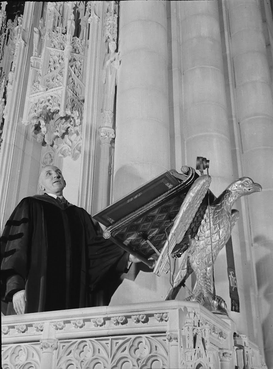 Rev. Eugene Carder Reading From Rostrum