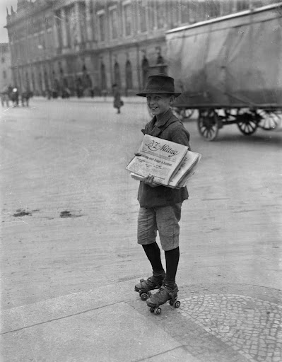 Traffic strike, eleven-year-old paperboy takes advantage of interrupted newspaper delivery to make a quick sale on roller skates