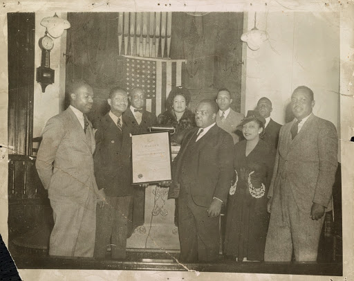 Kelly Alexander (left) receiving charter for Charlotte NAACP