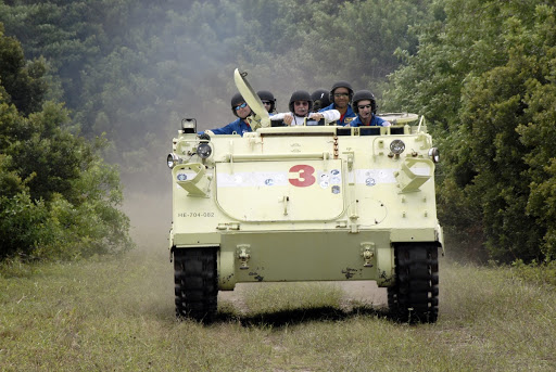 Charles O. Hobaugh takes his crew and instructor for a ride in an M113 armored personnel carrier during driving practice.