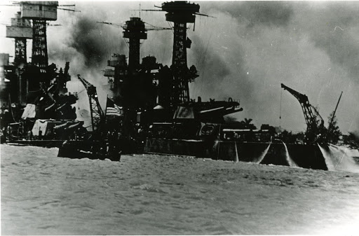 USS Tennessee BB-43 inboard of USS West Virginia - fighting fire started by debris and flaming oil from USS Arizona. Sinking USS West Virginia wedged USS Tennessee against two massive concrete piers and she could not move. Hit several times by bombs - USS Tennessee's two concrete piers were demolished by dynamite and were cleared away by 16 December. Arrived at Puget Sound Naval Shipyard on 29 December 1941 permanent repairs were commenced and returned to service on 25 February 1942. Returning to Puget Sound she was rebuilt and emerged again 7 May 1943. USS Tennessee earned a Navy Unit Commendation and ten battle stars for World War II.