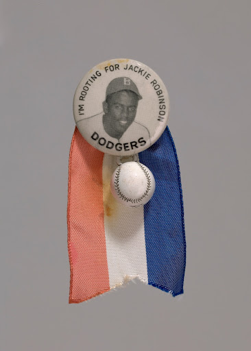 Pinback button of Jackie Robinson with baseball charm and ribbon