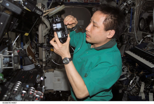 Expedition Seven Lu performs maintenance on camera