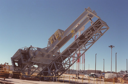 The X-33 weight simulator known as the iron bird is lifted to a vertical position at the X-33 launch site.