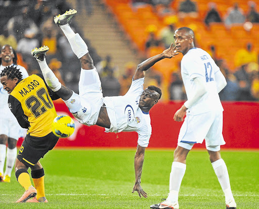 MAN DOWN: Edwin Gyimah, centre, of SuperSport United tumbles after colliding with Lehlohonolo Majoro of Chiefs during the PSL match at FNB Stadium last night. SuperSport stunned Amakhosi 2-1 Picture: GALLO IMAGES