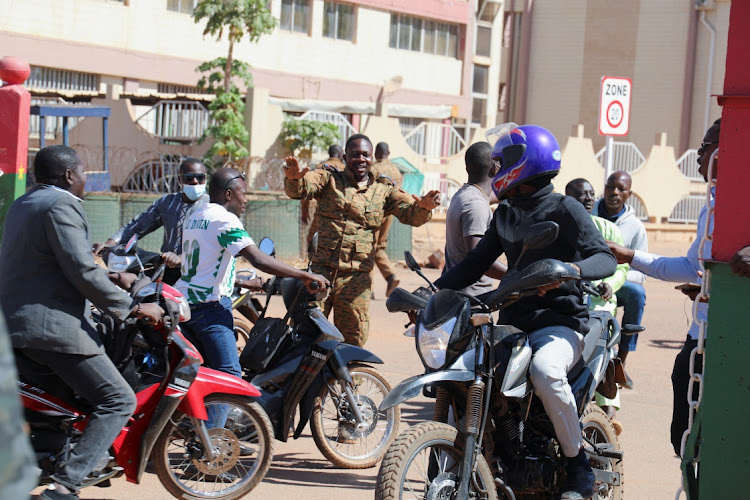 An army soldier asks people to disperse as they gather outside Guillaume Ouedraogo army camp to show their support for the military after Burkina Faso President Roch Kabore was detained at a military camp in Ouagadougou, Burkina Faso on January 24, 2022.