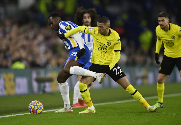 Chelsea's Hakim Ziyech challenges Brighton and Hove Albion's Danny Welbeck in their Premier League clash at The American Express Community Stadium, Brighton, on January 18, 2022