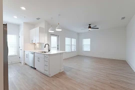 Open floorplan concept with wood finish flooring and neutral tones