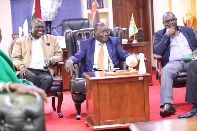 Governor Wilber Ottichilo (C) with his chief of staff James Otari in jacket and the county secretary Ezekiel Ayiego.