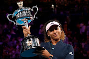 Japan's Naomi Osaka poses with her trophy after winning her match against Czech Republic's Petra Kvitova.  