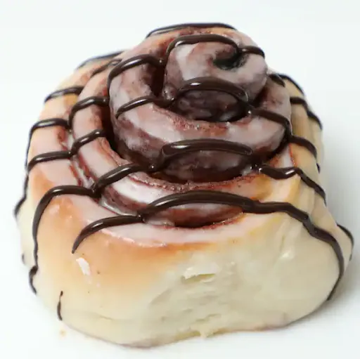 Glazed Cinnamon Roll With Chocolate Drizzle