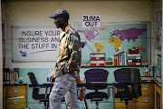 ASK THE MAN IN THE STREET: An advertising poster at a bus stop on Oxford Road, Johannesburg, to which a stark political message has been added