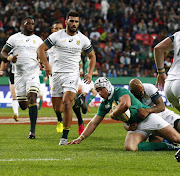 Luke Marshall (2-R) of Ireland is tackled by JP Pietersen of the Springboks (R) during the third and last Rugby Test match between South Africa and Ireland at Nelson Mandela Bay rugby stadium.