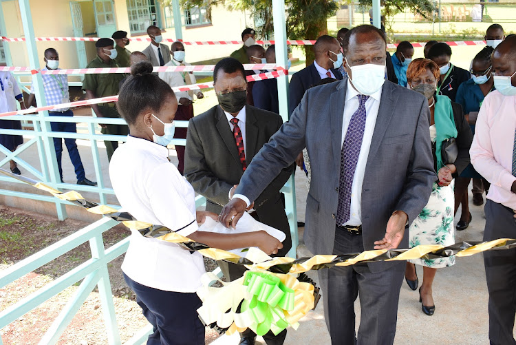 Kakamega Governor Wycliffe Oparanya cuts the ribbon during the launch of the Sh130 million 10-bed ICU ward at the county general hospital