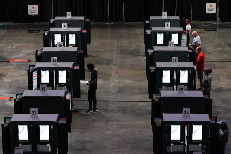 Residents cast ballots at an early voting polling location for the 2020 Presidential election in Atlanta, Georgia, U.S., on Monday, Oct. 12, 2020.