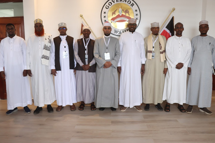 Wajir Governor Ahmed AbdullahiC] poses for a group photo with Clerics in his office on Monday.