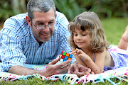 Zoe Grove learns to solve  a Rubik's Cube with her father Leon Grove. 