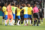 Mamelodi Sundowns and Orlando Pirates players remonstrate with each other and the match officials during the DStv Premiership match at Loftus Versfeld on Saturday night. 