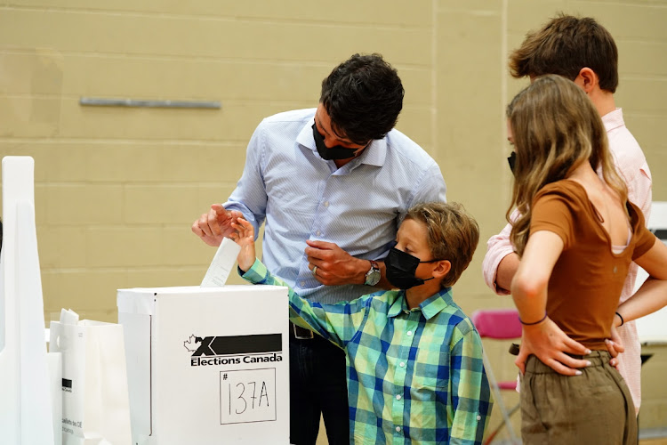 Canadian Prime Minister Justin Trudeau casts a ballot with his son, Hadrien, at a polling station in Montreal, Quebec, Canada, September 20 2021. Picture: SEAN KILPATRICK/CANADIAN PRESS/BLOOMBERG