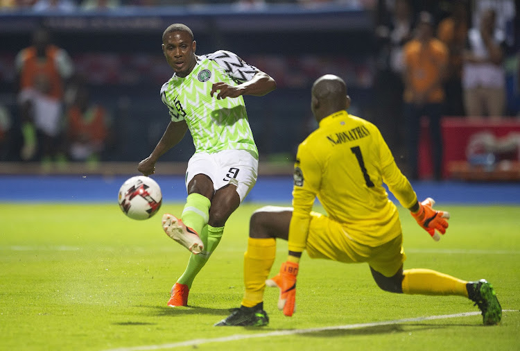 DELIVERED WITH CARE: Odion Ighalo of Nigeria, left, curls the ball past Jonathan Nahimina of Burundi to score the winning goal during last year's Africa Cup of Nations Group B match in Alexandria, Egypt. Ighalo is on loan to Manchester United from Chinese club Shanghai Shenhua