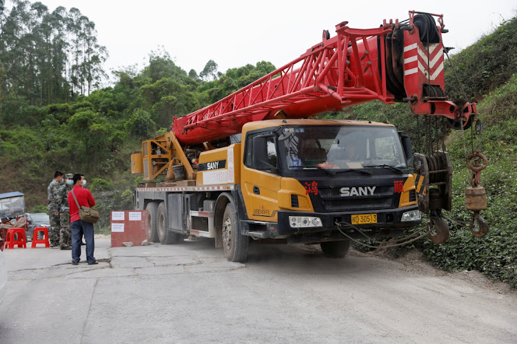 Machinery drives out from a road next to the entrance of Lu village near the site where a China Eastern Airlines Boeing 737-800 plane flying from Kunming to Guangzhou crashed, in Wuzhou, Guangxi Zhuang Autonomous Region, China on March 22 2022. Picture: REUTERS/CARLOS GARCIA RAWLINS