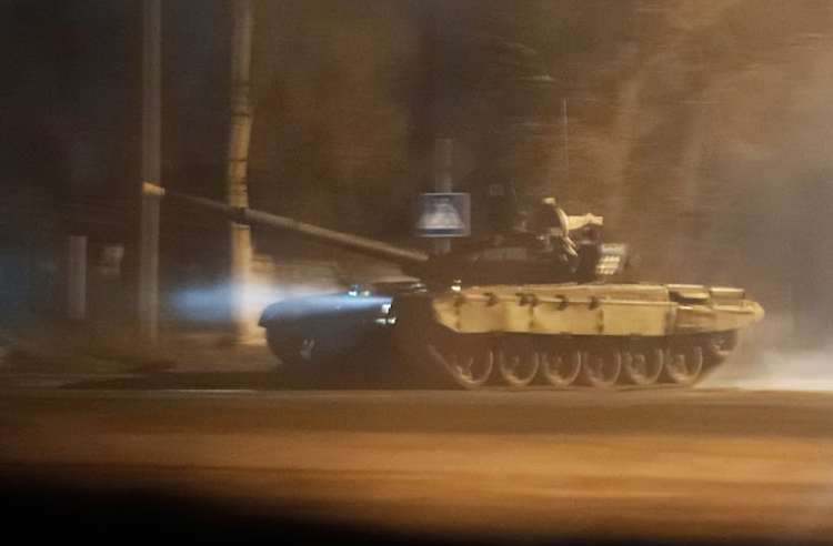 A tank drives along a street after Russian President Vladimir Putin ordered the deployment of Russian troops to two breakaway regions in eastern Ukraine following the recognition of their independence, in the separatist-controlled city of Donetsk, Ukraine, on February 22 2022.