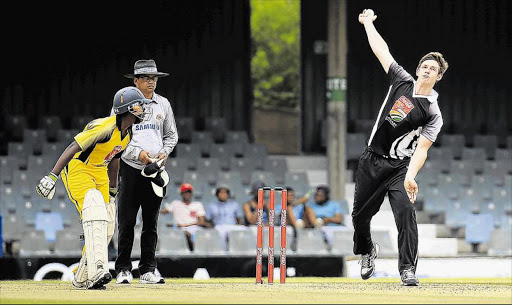 LETTING FLY: Selborne's Keoghan Penhall sends down a delivery while Queen’s Sakhe Zamane watches from the non-striker’s end during the Schools T20 Challenge match at Buffalo Park yesterday Picture: STEPHANIE LLOYD