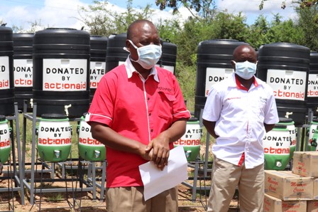 Mwachidudu Chimera of Action Aid presents a donation of hand washing equipment to residents of Makima ward in Mbeere South, Embu county