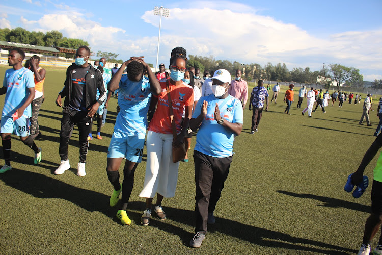 Kisumu County Sports Minister Achia Alai (C) consoles a Kisumu All Stars' player