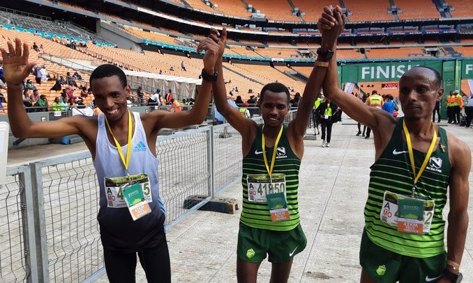 The Soweto Marathon podium finishers in the men's 42km race are winner Daba Ifa Debele, centre, second-placed Gadisa Bekele Gutama, right, and Tsepo Ramashamole at the finish at FNB Stadium, November 6 2022. Picture: SOWETO MARATHON/TWITTER