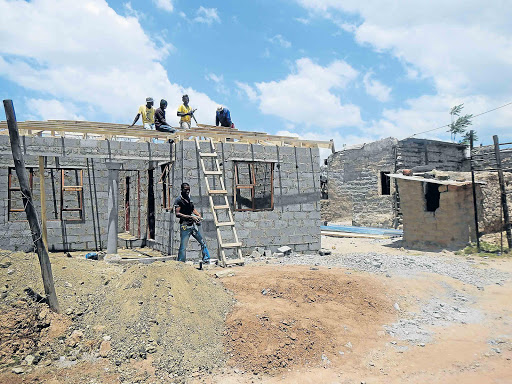 DREAM HOUSE: Themba Makhubele has come to the rescue of three siblings in Ncise village. They live in the mud house while Makhubele is busy constructing their new three-roomed house Picture: ABONGILE MGAQELWA